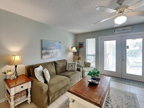 a living room with a couch and a table at Grand Caribbean Perdido Key #306 West in Perdido Key