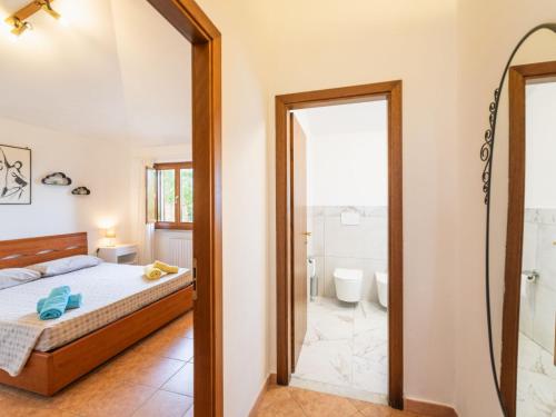 a bedroom with a bed and a bathroom with a mirror at Holiday Home Pilar by Interhome in Strada