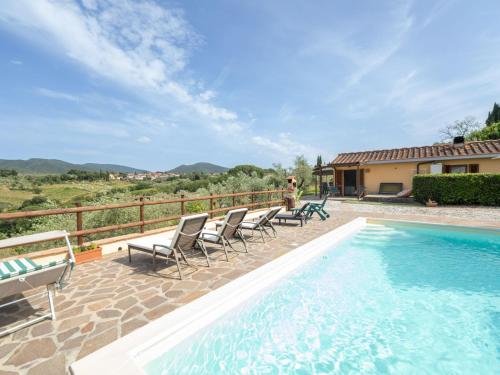 a villa with a swimming pool and chairs at Holiday Home Pilar by Interhome in Strada