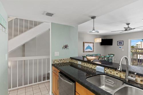 a kitchen with a sink and a counter top at Dolphin Cove- Pet Friendly Waterfront Townhome w Pool in Marathon