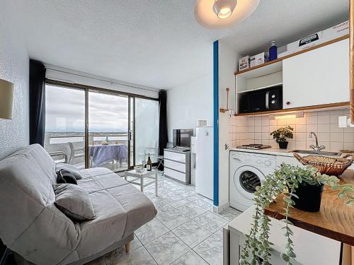 un salon avec un canapé et une cuisine dans l'établissement Apartment Les Marquises-6 by Interhome, au Barcarès