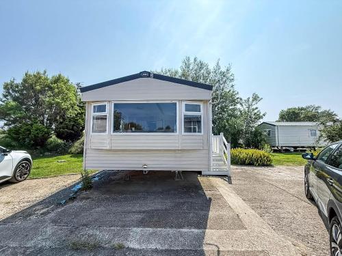 a tiny house is parked in a parking lot at Lovely 8 Berth Caravan With Decking And Wifi In Yorkshire, Ref 71011Ic in Tunstall