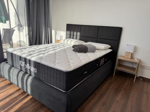 a bedroom with a firm mattress on a bed frame at Onero Residence Lovely Apartment in Paphos City