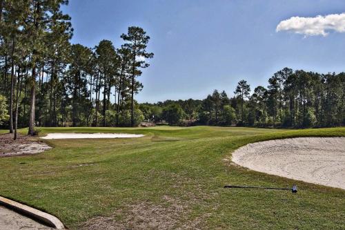 a golf ball laying on the ground on a green at Spacious 3 BR plus SS in Den & screened lanai waterside in Sampson