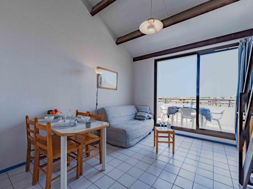 un salon avec une table et un canapé dans l'établissement Apartment Coudalère - Jamaica-5 by Interhome, au Barcarès