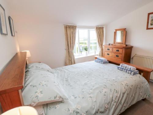 En eller flere senge i et værelse på Fairhaven Cottage