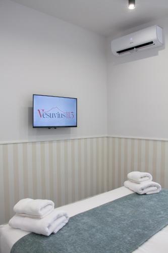 two towels are sitting on a bed in a room at vesuvius115 in Naples