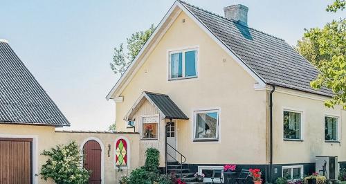 a large white house with a garage at Bright House With Field View In Österlen in Borrby