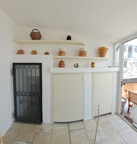 a living room with a fireplace and a white wall at Suite Verdi in Lecce