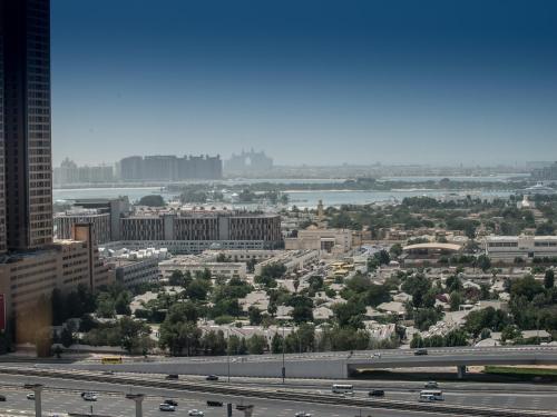 a view of a city with a highway and buildings at Grand Millennium Dubai in Dubai