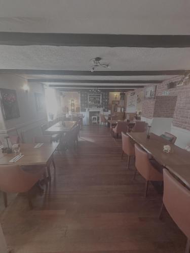 a dining room with tables and chairs in a room at Laburnum Guest House at Bistro En Glaze in Wylam