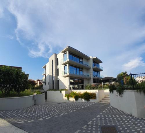 a large white building with a lot of windows at Hotel Oscar in Kaštela