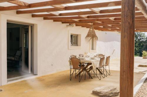 a dining room with a table and chairs at Monte da Serra de Baixo in Sines