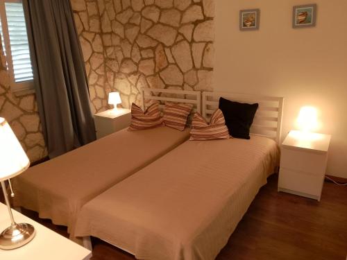 two beds in a room with two lamps at Suite Hvar Park Beach Villa, Hvar Ana Nikola Villas in Jelsa