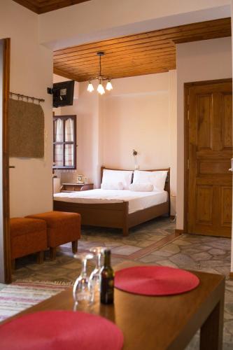 a bedroom with a large bed and a bathroom at Φιλυρέα Apartments - Room 4 in Zagora