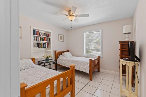 une chambre avec deux lits et un ventilateur de plafond dans l'établissement Little Venice Paradise - Waterfront Home, 55' Dock, à Marathon
