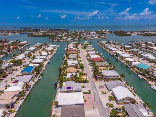 an aerial view of a harbor with houses and boats at Keys Dream - Luxury Waterfront Home, Beach Club w Pool, 37' Dock in Key Colony Beach