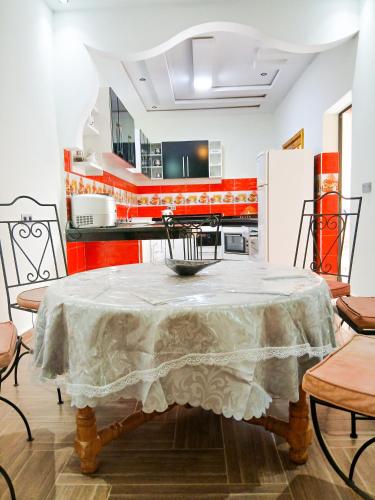 a kitchen with a table with a table cloth on it at villa ourika complette in Sbiti