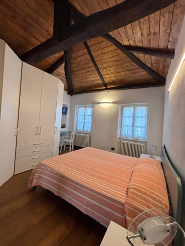 a bedroom with a bed and a wooden ceiling at La Torretta in Beverino