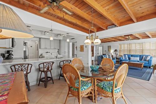 a kitchen and living room with a table and chairs at My Beach Key - Waterfront Home, 32' Dock, Tiki Hut, Beach Club Access w Pool in Key Colony Beach