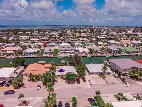 an aerial view of a resort with a marina at My Beach Key - Waterfront Home, 32' Dock, Tiki Hut, Beach Club Access w Pool in Key Colony Beach
