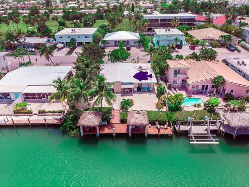 an aerial view of a resort on the water at My Beach Key - Waterfront Home, 32' Dock, Tiki Hut, Beach Club Access w Pool in Key Colony Beach