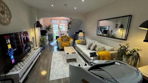 a living room with a couch and a tv at Coastguard Cottage in Isle of Wight