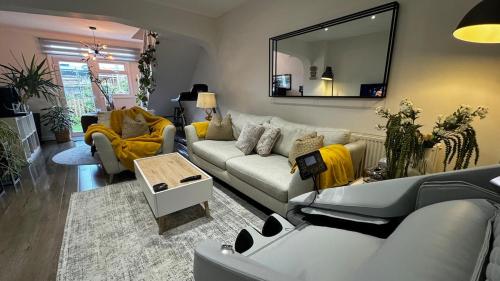 a living room with a couch and a mirror at Coastguard Cottage in Isle of Wight
