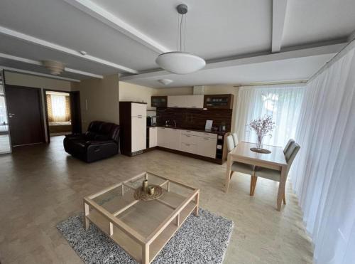 a living room with a couch and a table at Vila Nova Pervalka in Pervalka