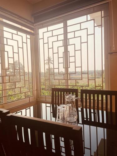 a table in a room with a large window at Dreams Arcade in Nedumbassery