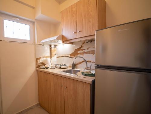 a kitchen with a refrigerator and a sink at Gemini in Laganas