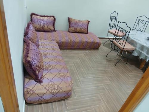 a living room with a couch and a table at villa ourika complette in Sbiti