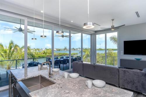 a kitchen and living room with a view of the ocean at Off the Hook - Luxury Waterfront Pool Home, Kayaks & Bikes, 30' Dock in Marathon