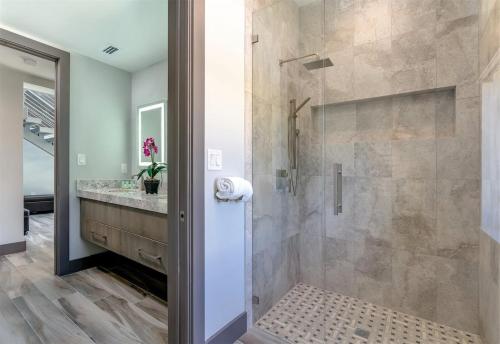 a bathroom with a shower and a sink at Off the Hook - Luxury Waterfront Pool Home, Kayaks & Bikes, 30' Dock in Marathon
