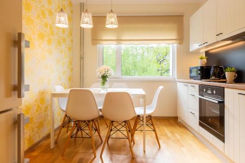 a kitchen with a dining room table and chairs at Aardla Cozy Apartment in Tartu