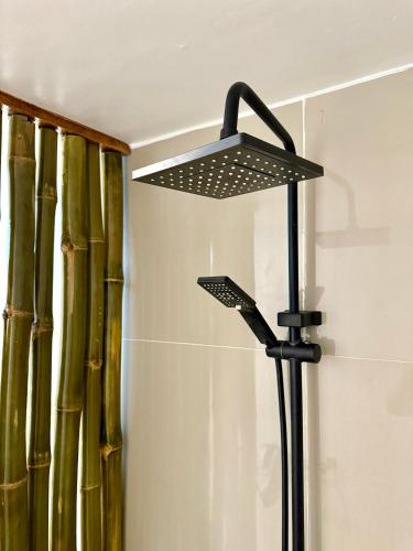 a black lamp in a bathroom with bamboo at Utopia Port Barton in San Vicente