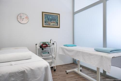 a hospital room with two beds and a mirror at Priska Med Luxury Rooms in Split