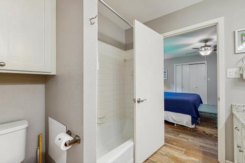 a bathroom with a tub and a bedroom at Ski Shores in Kingsland