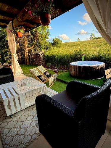 a patio with a pool and a table and chairs at Bezdroża Mazurskie in Mrągowo