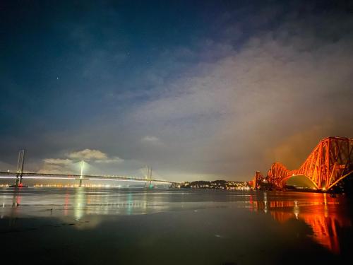 a view of a bridge over a river at night at Boreland Lodge Hotel in Inverkeithing