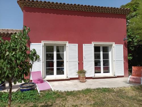 une maison rouge avec deux chaises devant elle dans l'établissement villa ensues la redonne proche calanques, à Ensuès-la-Redonne