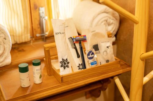 a shelf with towels and toiletries on it in a bathroom at Shivadya - A Luxury Boutique Experience in Manāli