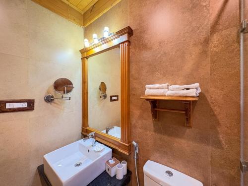 a bathroom with a sink and a mirror at Shivadya - A Luxury Boutique Experience in Manāli