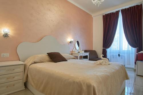a bedroom with a large bed and a window at Museum Guest House in Civitavecchia