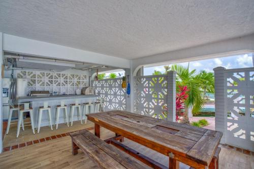 a porch with a wooden bench and a bar at Sailfish Point - Luxury Waterfront Pool Home, 80' Dock in Key Colony Beach