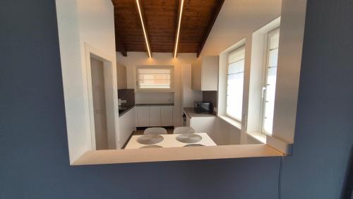 a room with two chairs in a room with two windows at Alps lodge in Domegge di Cadore