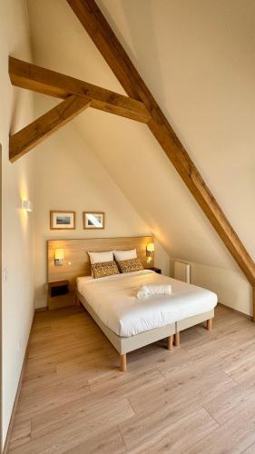 une chambre avec un grand lit dans un grenier dans l'établissement 9 - Seigneurie Fouquet - Pesmacody, au Palais