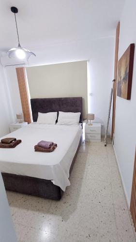 a bedroom with a large white bed in a room at Modern 2bd appartment near mall- Internet 1Gbps in Paphos