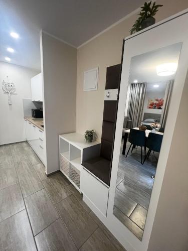 a small apartment with a kitchen and a dining room at Dih narave in Stahovica