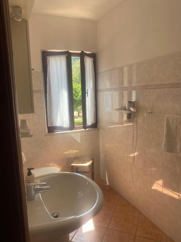 a bathroom with a tub and a shower and a sink at Appartamenti Anna in Rio Marina
